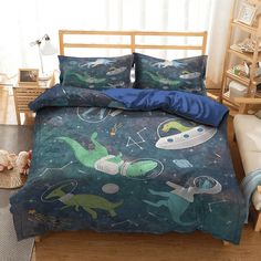 a bed room with a neatly made bed covered in blue sheets and dinosaur print on it