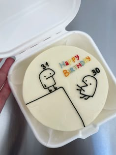 a birthday cake in a plastic container with the words happy birthday written on it's side