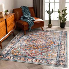 a living room area with a chair, rug and cacti