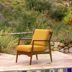 a yellow chair sitting on top of a tiled patio