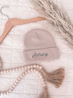 "Create a heartwarming, one-of-a-kind keepsake for your little one with our Personalized Newborn Beanie. This soft, cozy winter hat is expertly stitched with your baby's name, making it the perfect name announcement accessory. Crafted with warm and hypoallergenic 100% acrylic, this infant beanie is gentle on delicate skin while ensuring your baby stays comfy and toasty. Customize your baby's beanie hat by selecting one of our four stylish beanie colors and pairing it with one of 36 vibrant embroidery thread colors. Fine-tune your design with a choice of 5 fun fonts. This custom name hat is not just a snuggly winter essential but also a charming keepsake of your baby's early days. It makes a thoughtful, personalized baby gift for winter-born infants, perfect to gift on baby showers or baby' Name Baby Girl, Infant Beanie, Personalized Baby Hat, Handmade Baby Items, Fun Fonts, Newborn Beanie, Baby Shoot, Personalized Newborn