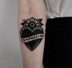 a woman's arm with a tattoo on it that says, compassion