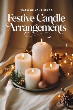 candles are arranged on a plate with pine cones and lights in the background text reads, warm up your space festive candle arrangements