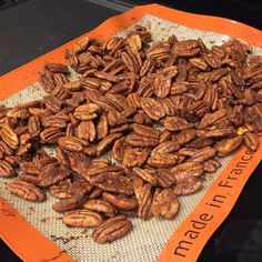 a pile of pecans sitting on top of an orange tray