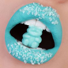 a woman's mouth with blue and white decorations on the top of her lips