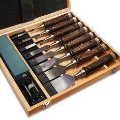 a wooden box filled with different types of knives