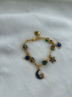 Embark on a journey through the cosmos with our handcrafted space-themed gold bracelet. Perfect for astronomy enthusiasts and stargazers, this bracelet brings the beauty and mystery of the universe to your wrist. Astronomy Jewelry, Gold Armband, The Cosmos, Charm Bracelets, Astronomy, Cosmos, Favorite Jewelry, Beauty Book, Jewelry Bracelets