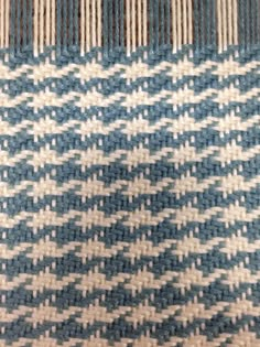 a close up view of a blue and white checkered fabric with some lines on it