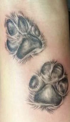 an animal paw tattoo on the leg