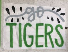 a piece of paper with the words tigers painted on it