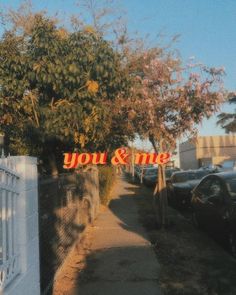 a sign that says you and me on the side of a road