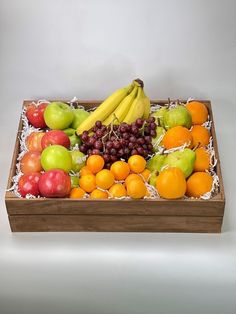 a wooden box filled with lots of different types of fruit