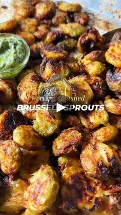 fried brussel sprouts with green dipping sauce on the side, ready to be eaten