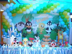 an image of a birthday party setting with balloons and animals on the table in front of it