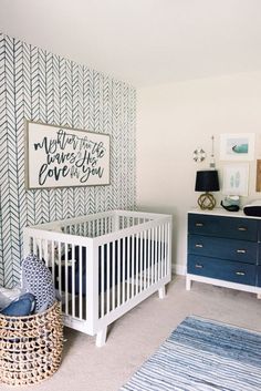 a baby's room with blue and white decor