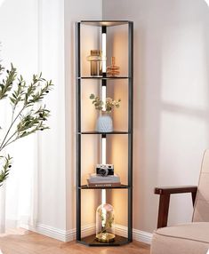 a room with a chair, vase and bookshelf