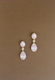 Our Stunning AWE Drop Earrings with Swarovski Crystals are Absolutely Gorgeous. The design includes a combination of big Swarovski crystals and cubic zirconia crystals. The pair of earrings are the perfect touch to any look to give it a fancy and gorgeous touch. The earrings can be styled with most of our wedding headpieces, Bridal Tiaras and Crowns. Handcrafted Highest Quality Swarovski / Cubic Zirconia Platinum plated Guards against scratches and tarnish. approximate size 1" length 0.5" width Wedding Drop Earrings, Crystal Wedding Earrings, Wedding September, Crystal Wedding Necklace, Inspo Pictures, Bridal Tiaras, Wedding Headpieces, Crystals Earrings, Crystal Wedding Jewelry