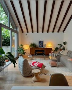 a living room filled with furniture and lots of windows