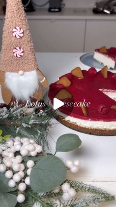 two pies with christmas decorations on them sitting on a table next to each other