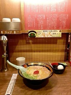 a bowl of soup sitting on top of a wooden table