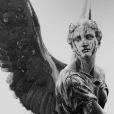 an angel statue is shown in black and white