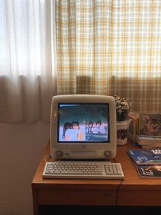 an old computer sitting on top of a wooden desk