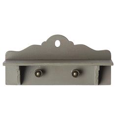 two hooks are attached to the side of a gray wall mounted coat rack with three knobs