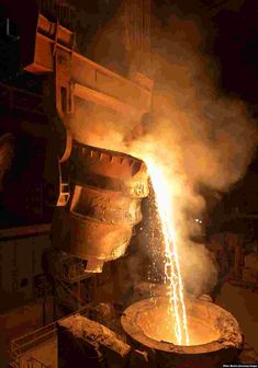 a large metal object being worked on by a machine with sparks coming out of it