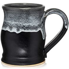 a black and white coffee mug on a white background with the bottom half covered in gray speckles