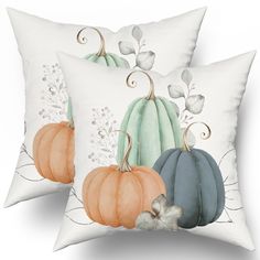 two decorative pillows with pumpkins on them