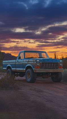 A classic blue Ford truck with rugged off-road tires navigates a dusty trail surrounded by cacti and mountains. Blue Ford Truck, Ford Trucks F150, Ford Suv, Packing Essentials, Old Ford Trucks, Safety Precautions, Ford Pickup Trucks, Classic Vehicles, Old Fords