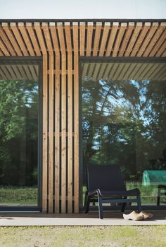 a black chair sitting in front of a wooden structure