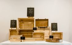 several wooden boxes stacked on top of each other with chalkboards attached to the lids