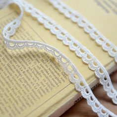 an open book with white lace on it