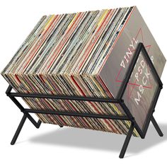 a stack of records sitting on top of a metal stand