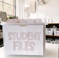 a sign that says student files on it in front of some bookshelves and shelves