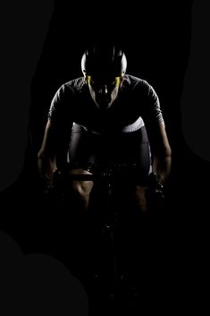 a man riding a bike in the dark