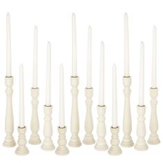 white candles are lined up in rows on a white background, with one candle lit and the other turned off