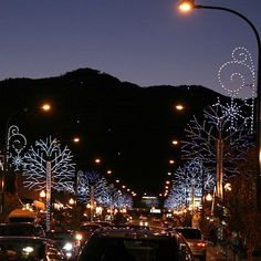 the street is lit up with christmas lights