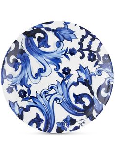 a blue and white plate with an artistic design on the front, against a white background