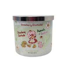 an empty glass jar filled with strawberry shortcakes and other items on a white background