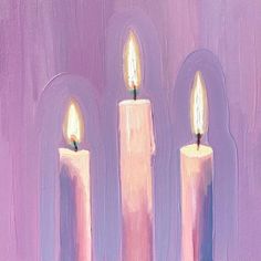 three lit candles in front of a purple background