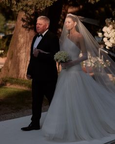 the bride and groom are walking down the aisle at their outdoor wedding ceremony in an elegant setting