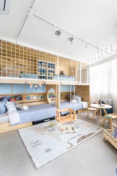 a child's bedroom with bunk beds, desks and toys on the floor