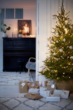 a small christmas tree with presents under it