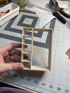 someone is making a miniature house out of wood