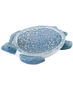 a blue turtle statue sitting on top of a white surface