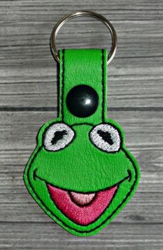 a green key chain with a smiling face on it