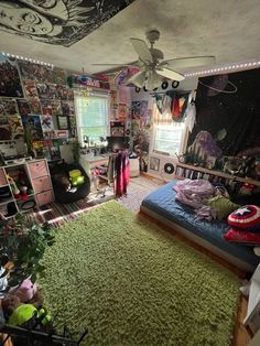 a bedroom with green carpet and lots of pictures on the wall