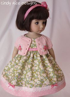 the doll is wearing a dress with flowers on it